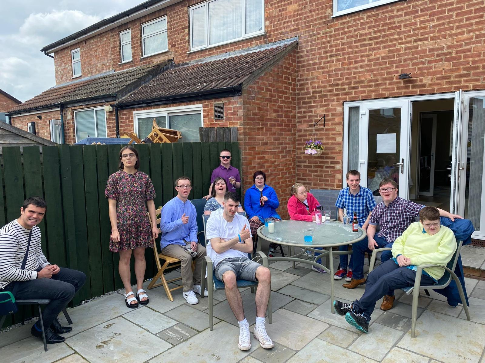 People sitting outside their house